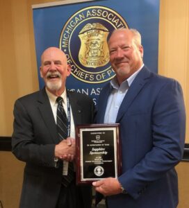 Pictured left, Chief Robert Stevenson (Ret.) is President of MACP. Robert J Turner Foundation President Cory Williams (right) represents RJTF at the Michigan Association of Police Summer Professional Development conference and awards banquet. 